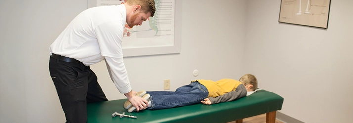 Chiropractor Reading PA Jason Balthaser Adjusting Pediatric Patient Using Activator Tool