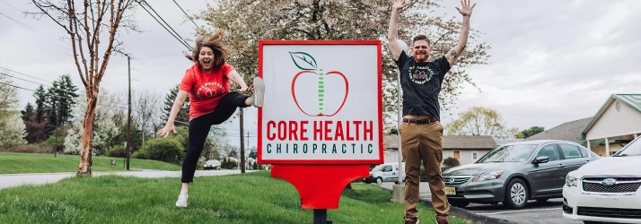 Chiropractor Reading PA Sarah Balthaser And Jason Balthaser With Office Sign